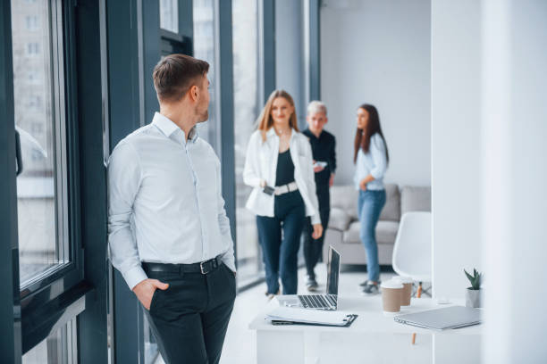 istock Group of young successful team that working and communicating together indoors in office 1323868312