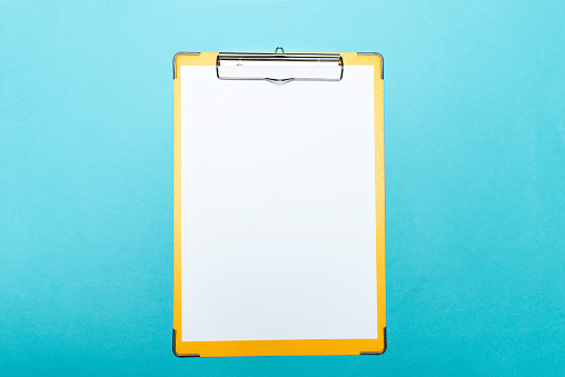 Clipboard with blank paper on blue background.