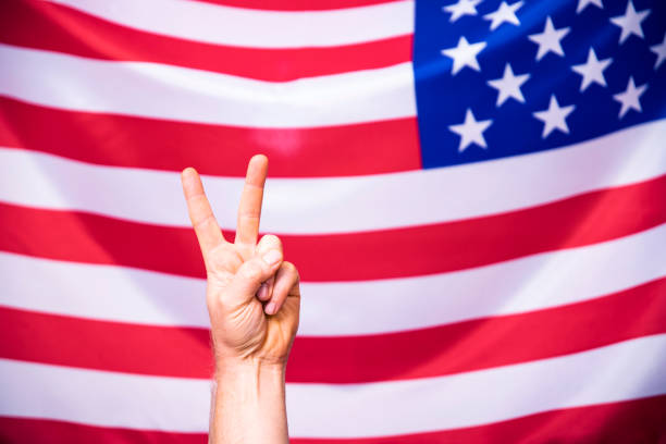 istock American flag with victory sign 1323869013