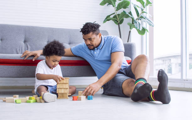 istock African father is playing with his son 1323870980