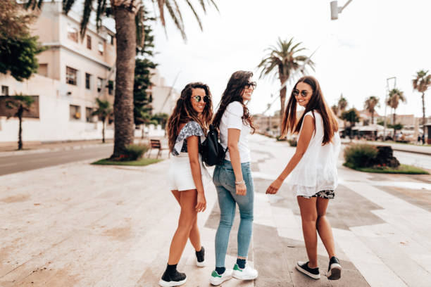 istock friends walking in the city 1323871124