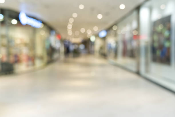istock shopping mall blurred background. Light blur store interior with bokeh 1323873318