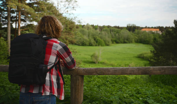 istock Male tourist with backpack enjoying the nature. 1323873439