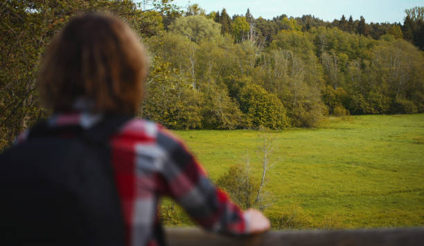 istock Male tourist with backpack enjoying the nature. 1323873449