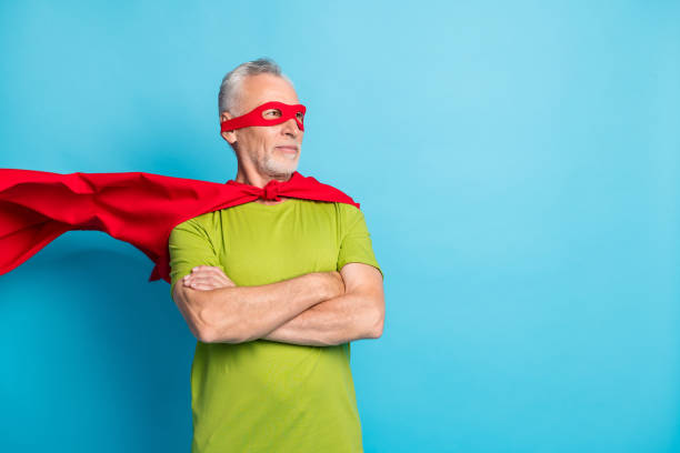 Portrait of attractive strong grey-haired superman folded arms copy empty space isolated over bright blue color background