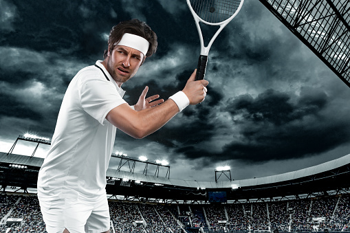 Tennis player with racket in white costume. Man athlete playing isolated on light background