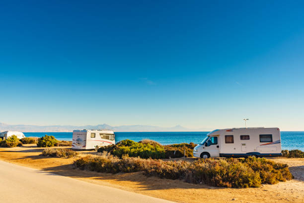 istock Camper cars on beach, camping on seashore 1323880237