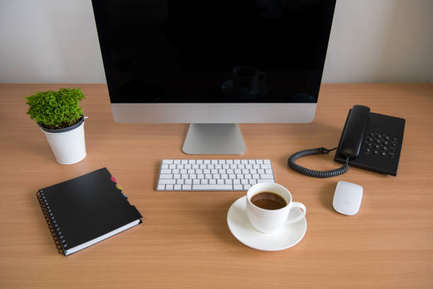 istock Office table with personal computer, note book, phone, keyboard, mouse, coffee cup and plant pot 1323881843