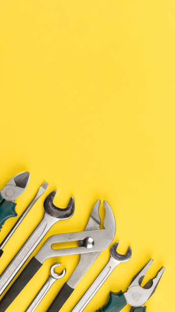 istock Work tools on bright yellow background with copy space. Top view, flat lay. Vertical photo 1323883391