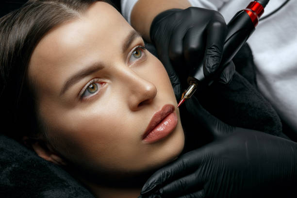 istock Wonderful brunette woman having lip permanent 1323883392