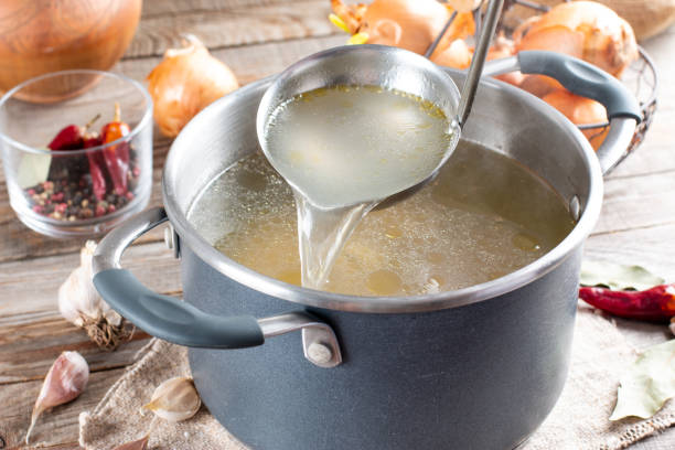 istock Saucepan with bouillon with a ladle. Bone broth 1323883516