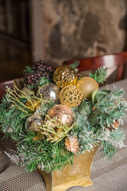 istock Christmas candle and decorations on table with copy space. Vintage decor, decorations in a basket, lanterns, garlands,spruce branches on a white table.Details Scandinavian living room for Christmas. 1323883525