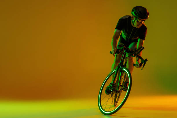 istock Cyclist riding a bicycle isolated against neon background 1323883676