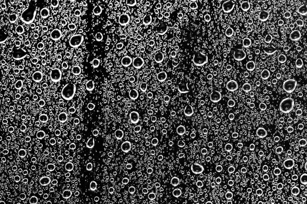 istock Water drops on glass black and white 1323884881