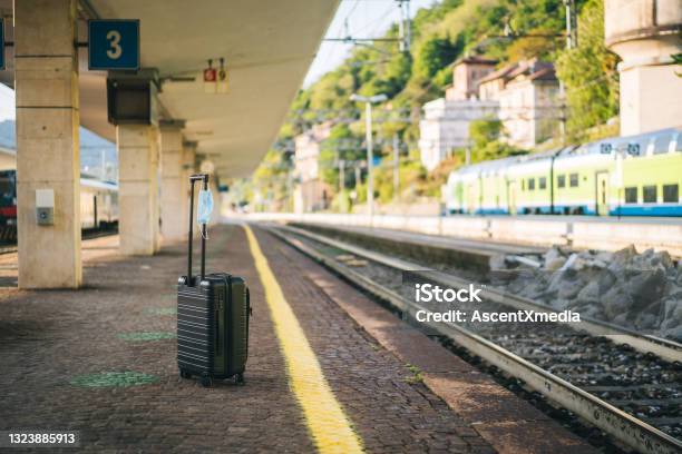 Scenic View Of Suitcase Sitting At Platform Of Train Station Stock Photo - Download Image Now