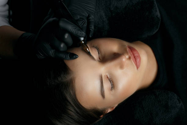 istock Pretty woman having eyebrow permanent 1323886201
