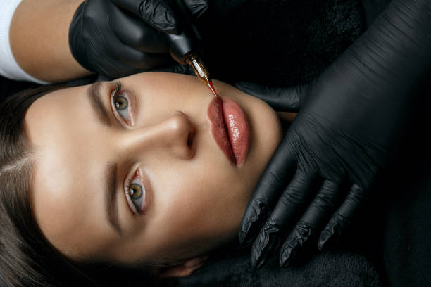 istock Gorgeous brunette woman having lip permanent 1323886208