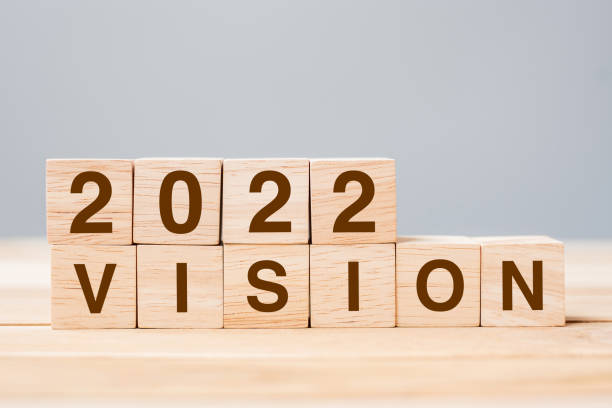 istock 2022 VISION cube block on table background. Resolution, plan, review, goal, start and New Year holiday concepts 1323889830