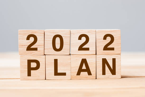istock 2022 PLAN cube block on table background. Resolution, GOAL, review, change, start and New Year holiday concepts 1323889847