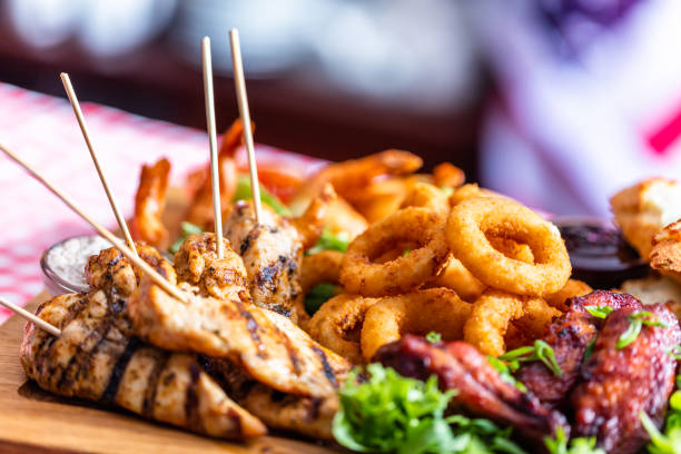 Grilled snack plate served in american restaurant. Onion rings, chicken etc