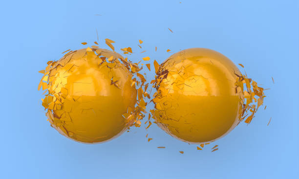 istock metallic orange spheres that collide and fragment. 1323891811