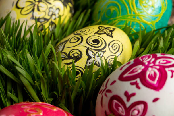 istock Many colored with ornaments eggs on green grass 1323892954