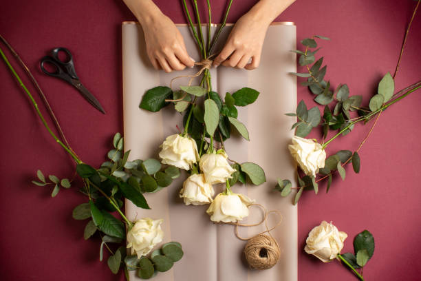 istock Woman making bouquet from white roses 1323893986