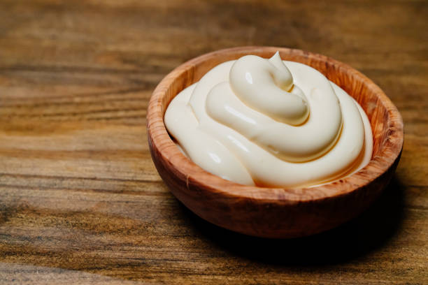 istock white sauce. small wooden bowl with mayonnaise on the kitchen table. 1323895061