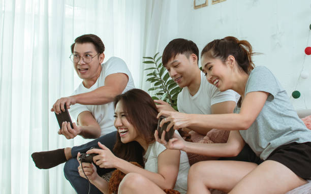 istock Asian people playing games together 1323895561
