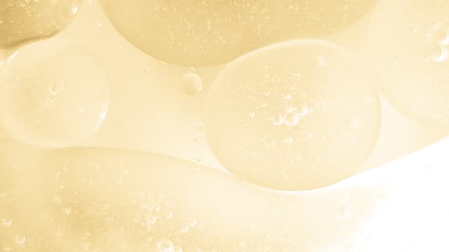 Oil bubbles floating on water surface, macro shot, abstract background