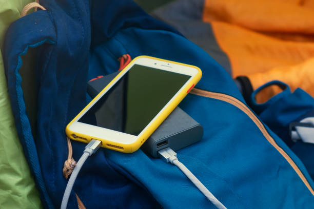 istock Smartphone is charged using a portable charger. Power Bank charges the phone outdoors with a backpack for tourism in nature. 1323902145
