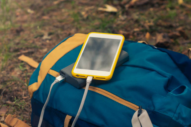 istock Smartphone is charged using a portable charger. Power Bank charges the phone outdoors with a backpack for tourism in nature. 1323902149