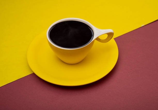 istock Closeup view of yellow cup filled with black coffee 1323902313