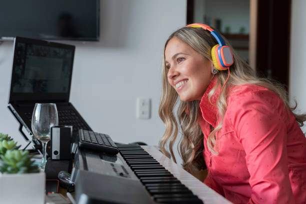 istock Singing teacher uses her hands to explain to her singing students where the voice goes. 1323903651