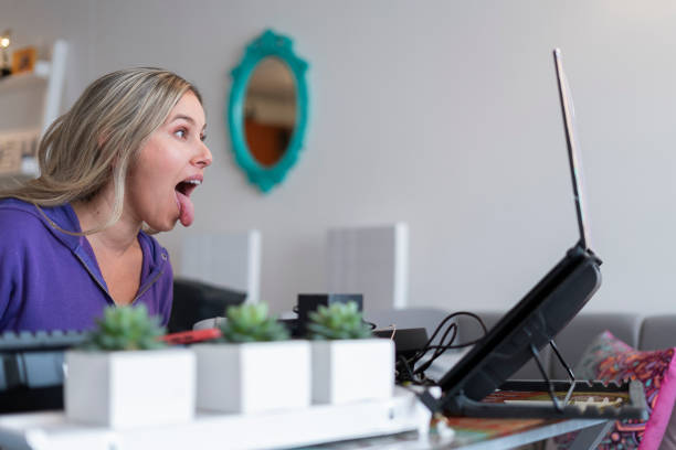 istock The singing teacher performs mouth and tongue exercises while giving her virtual singing classes wearing her pajamas from home. 1323904379