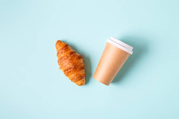 istock Coffee to go in a paper cup with croissants 1323904479