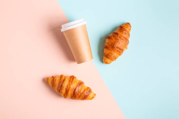 istock Coffee to go in a paper cup with croissants 1323904502