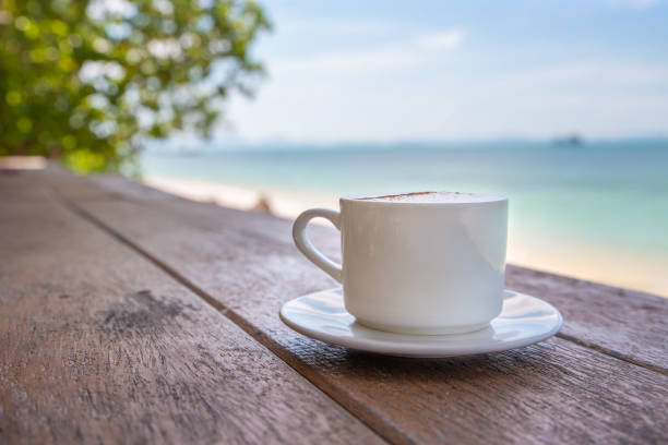 istock White cup of coffee on wooden tabletop 1323904968