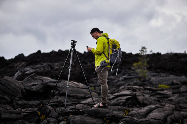 istock Hiker takes out his camera and tripod to shoot a time lapse 1323905679