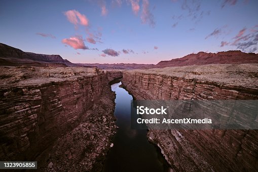 istock Scenic view of river running through canyon at sunrise 1323905855