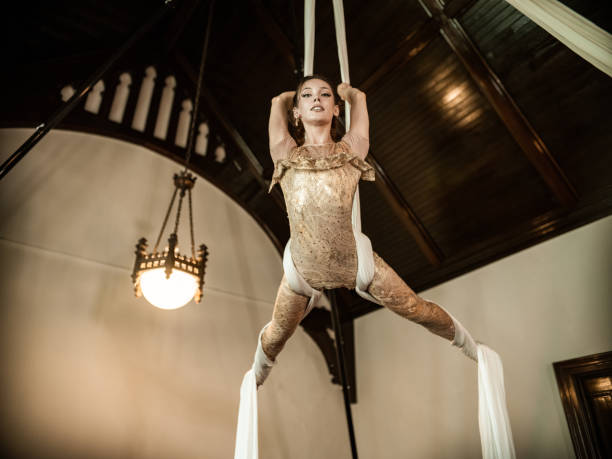 istock Young female aerial silk performer at practice 1323905920