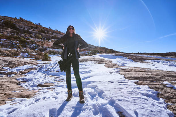 istock Young woman hikes along sandstone cliffs in springtime 1323906218