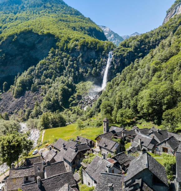 aerial image of the waterfall over the village foroglio in bavona valley - switzerland ticino canton valley church imagens e fotografias de stock