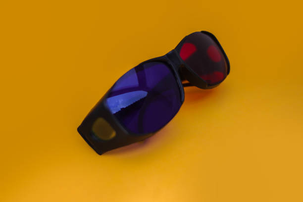 istock 3D cinema eyeglasses isolated on orange background. 1323908526