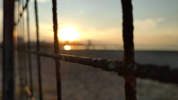 istock Selective focus of a metallic fence with Sun light background 1323913081