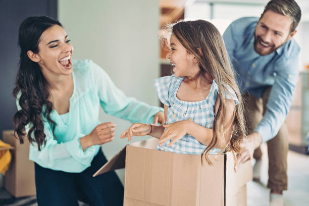 istock Little girl in a cardboard box while moving house 1323913758