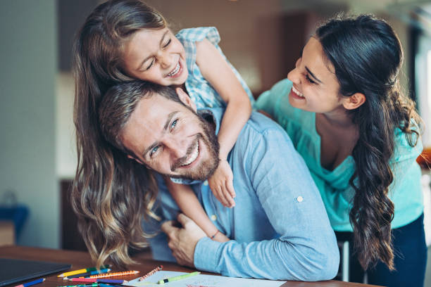 istock Father, mother and daughter having fun together 1323913767
