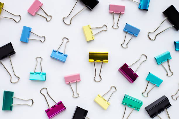 istock Colorful office paper clips on white background. 1323914646