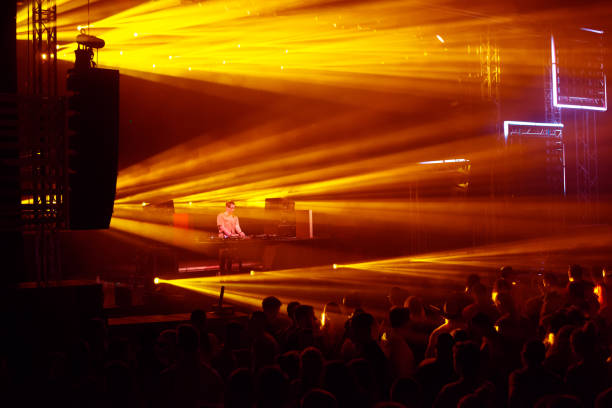 Dj playing on the concert stage at summer night.