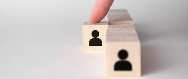 istock hand take wooden cube with man icon. Leadership concept 1323915840